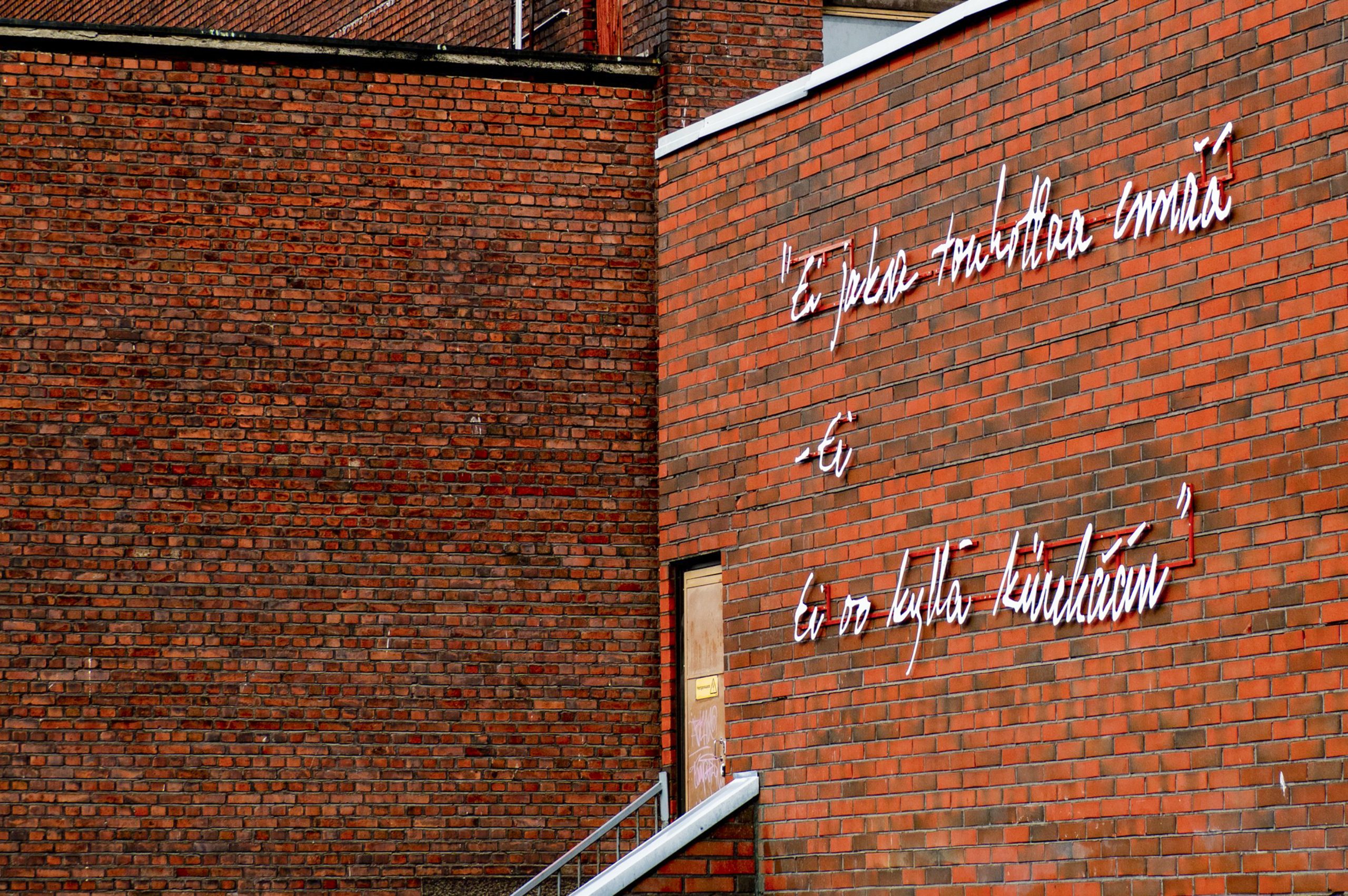 Brick wall, Tampere, with lyrics and poem