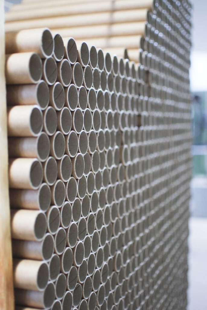 lots of round gray card board rolls